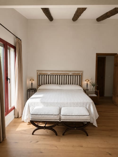 Bright bedroom at El Escondite De Pedro Malillo in Candeleda with striped headboard, exposed beams, and rustic charm