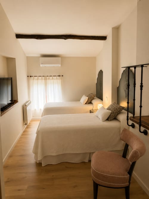 Twin bedroom with beamed ceiling at El Escondite De Pedro Malillo, a charming B&B in Candeleda, Spain