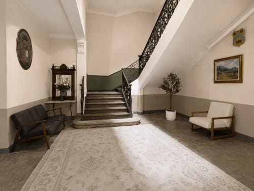 Elegant staircase in Suite Mirabeau at Les Suites de Montigny, Aix-en-Provence, with mid-century seating and refined décor