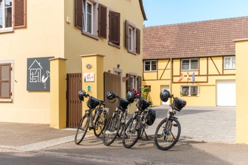 Four bikes parked at Les Ambrades hotel courtyard in Sigolsheim, Alsace wine region