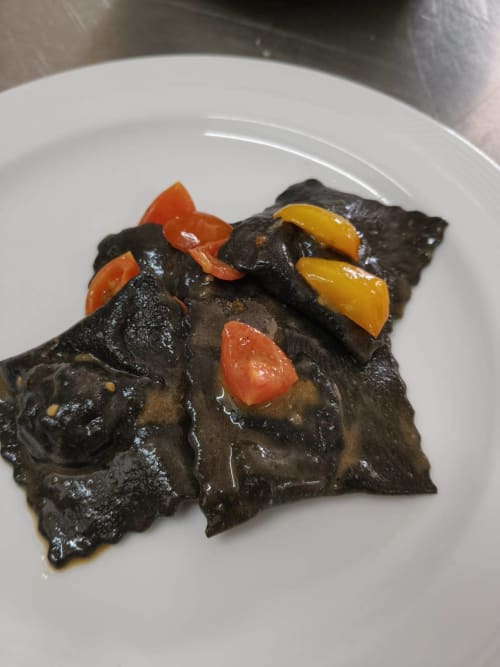 Squid ink pasta with roasted peppers served at Hotel Ristorante alle Querce in Castelbuono