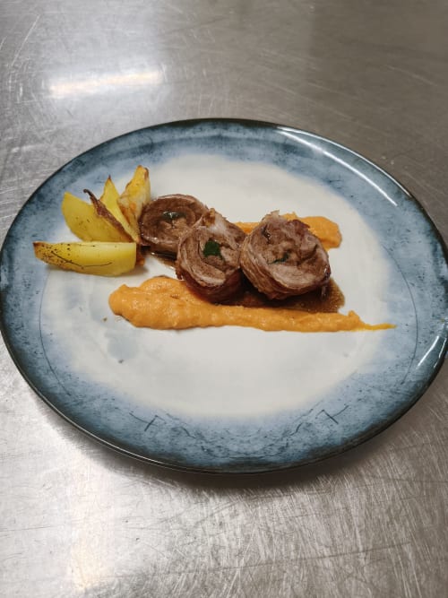 Plated dish at Hotel Ristorante alle Querce: rolled meat with roasted potatoes and carrot purée on cream sauce, Castelbuono