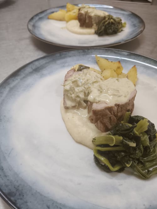Plated pork with creamy sauce, roasted vegetables, and potatoes at Hotel Ristorante alle Querce, Castelbuono