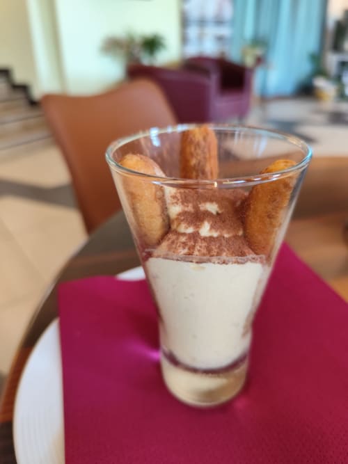 Layered tiramisu dessert in glass at Hotel Ristorante alle Querce, Castelbuono