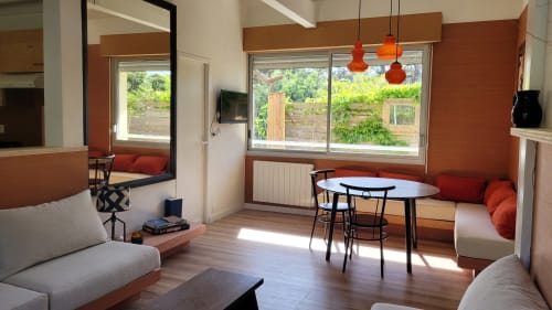 Modernes Apartment im Lodge du Cap Ferret mit orangefarbenen Akzenten, Sitzbereich, Esstisch und Gartenblick