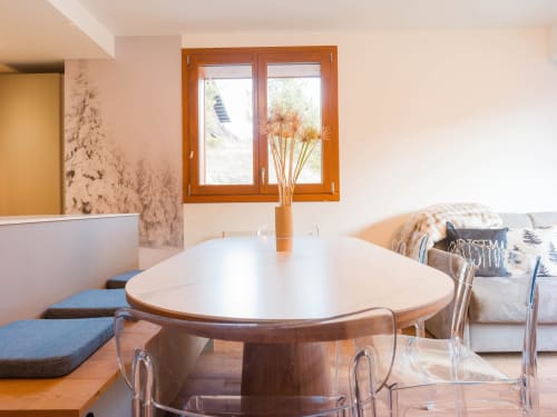 Salle à manger contemporaine dans l'appartement Sage des Montagnes aux Tanières de Montgenèvre avec table ronde blanche, vue sur les montagnes