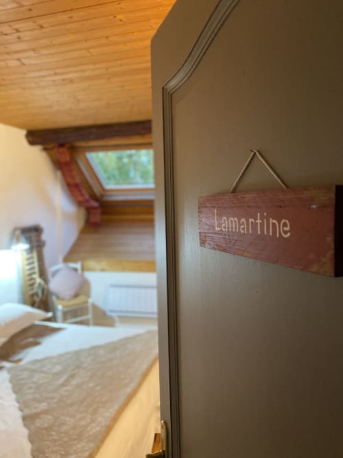 Wooden door sign reading 'Lamartine' at La Jument Verte B&B in Trévignin, France