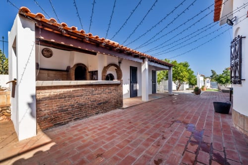 Quinta do Águas villa in Lagoa with white-washed walls, terracotta roof, brick BBQ area, and red clay patio overlooking the