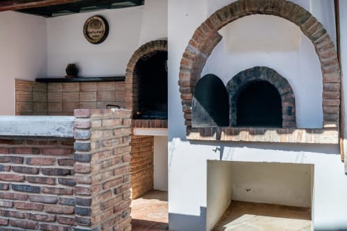 Brick barbecue with arched oven at Quinta do Águas villa in Lagoa, Portugal, featuring outdoor dining setup