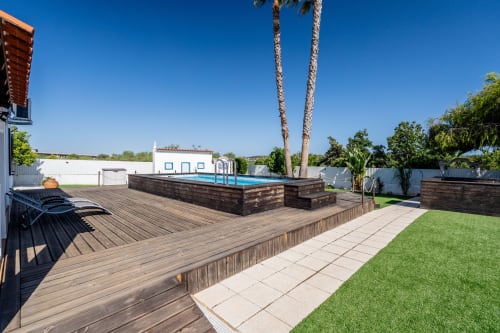 Luxury villa with wooden deck, private pool, and manicured garden in Lagoa, Portugal