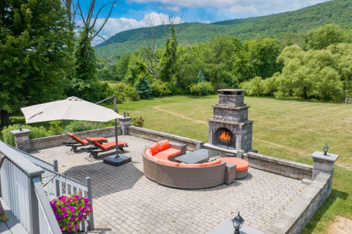 Mountain view patio at Malkita Aria with fire pit, outdoor seating, fireplace, and Woodbury hillside backdrop