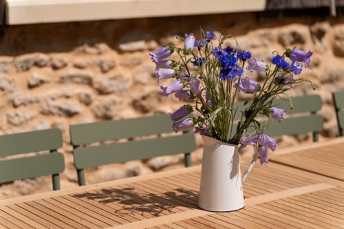 Fleurs violettes dans un vase blanc sur la terrasse en bois des Maisons Noisette, Saint-Pierre-des-Ormes