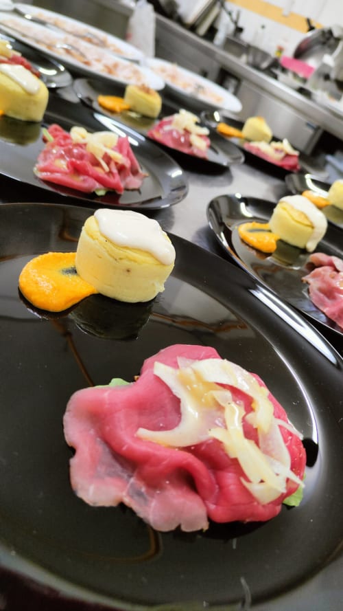 Gourmet desserts plated on black spoons at Hotel Ristorante alle Querce in Castelbuono, Italy