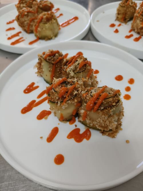 Gourmet plated dish with breaded cutlet and red sauce drizzle at Hotel Ristorante alle Querce, Castelbuono
