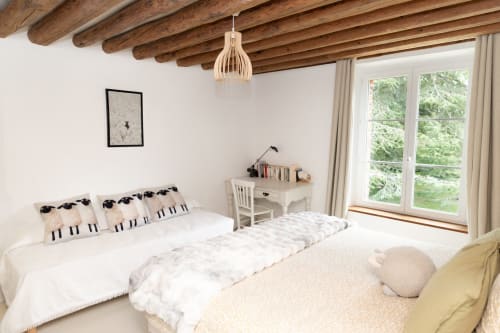 Chambre confortable aux Lodges de la Ferme de la Chaise avec poutres apparentes, deux lits, bureau, vue sur jardin et lumière naturelle