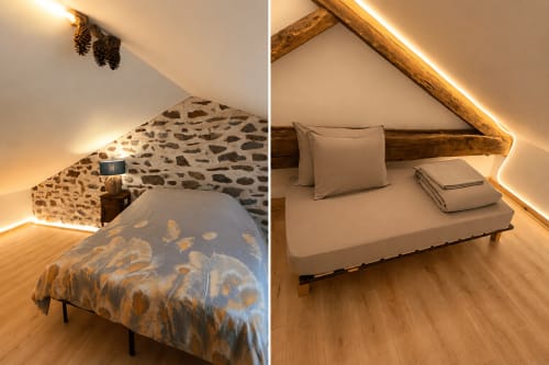 Cozy attic bedroom at Domaine de Beau Site cottage in Peyrat-de-Bellac with wooden beams, warm lighting, and garden views