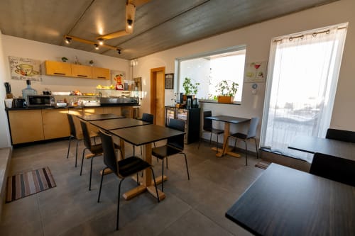 Modern kitchen and dining area with city view at Estrella Lodging apartment in Rabat, featuring wooden cabinets and black