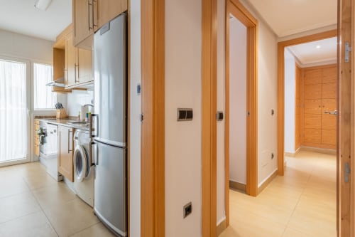 Modern kitchen and hallway in El Alcázar apartment at Haus Holiday Homes, San Pedro del Pinatar, with stainless steel