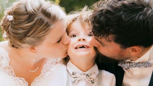 Happy family moments at Ô Château hotel in Hayange, parents kissing child in festive attire