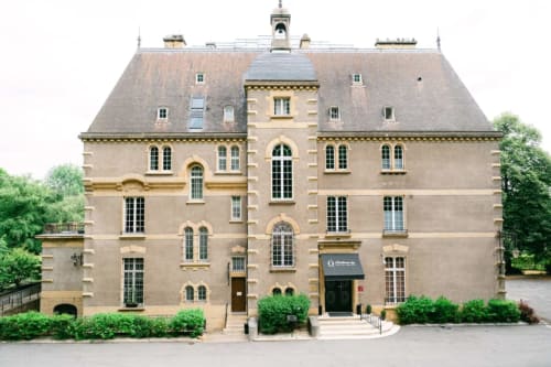 Ô Château hotel in Hayange features a grand stone mansion with mansard roof and arched windows