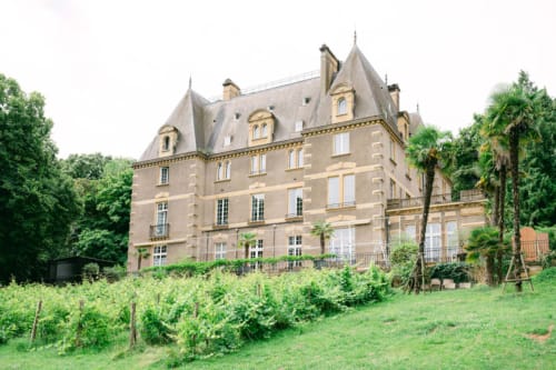 Ô Château hotel in Hayange, France - grand stone mansion with mansard roof and vineyard grounds