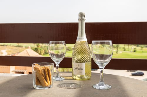 Prosecco bottle with glasses and breadsticks on terrace at Haus Holiday Homes, San Pedro del Pinatar