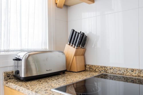 Kitchen counter with stainless steel toaster and wooden knife block in Haus Holiday Homes apartment, San Pedro del Pinatar