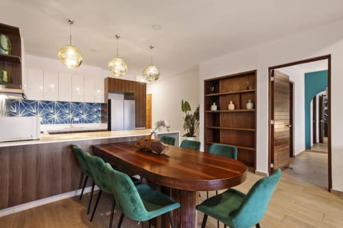 Modern kitchen and dining area at Malkita Sol in Isla Mujeres with wood table, turquoise chairs, and ocean view access