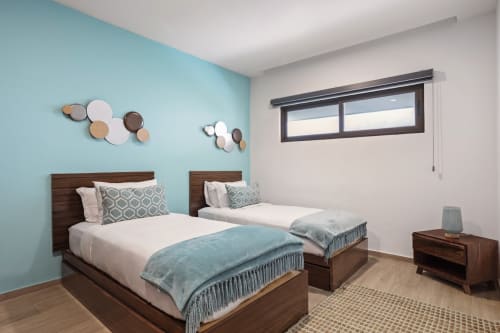 Twin beds with turquoise accents in oceanview bedroom at Malkita Sol, Isla Mujeres resort apartment
