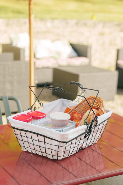 Picnic basket with breakfast items at Le Hameau de Céline B&B in Landes-le-Gaulois, France