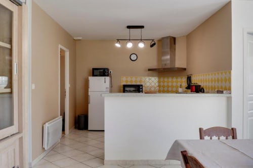Cuisine et salle à manger modernes du gîte L'escapade de Sauvagnac aux Petits Toits, Libourne, avec accents jaunes