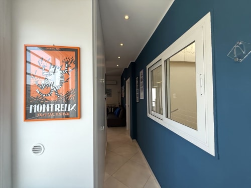 Corridoio moderno dell'Appartamenti Bari con parete blu, poster di Montreux incorniciato e design contemporaneo