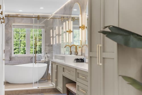 Luxurious bathroom in Malkita Terra villa with marble finishes, gold fixtures, freestanding tub, and mountain views in