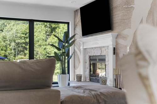 Modern villa living room at Malkita Terra in Woodbury with fireplace, TV, and mountain views through large windows