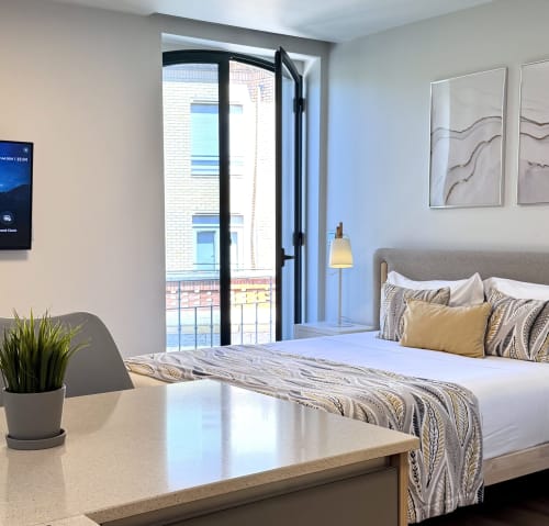 Quarto de hotel moderno no RIA CENTRUM em Aveiro com móveis premium, varanda e área de trabalho