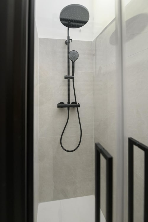 Soffione e doccetta manuale in nero moderno nella suite bagno Rubino Design presso l'hotel Almatros di Sulmona