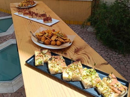 Appetizers displayed on wooden table at Hotel Ristorante alle Querce in Castelbuono
