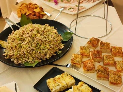 Buffet spread at Hotel Ristorante alle Querce featuring stir-fried noodles, garlic bread, and sliced meats in Castelbuono