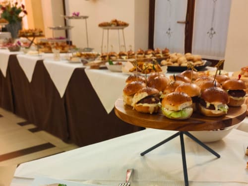 Elegant buffet display of gourmet sliders and appetizers at Hotel Ristorante alle Querce in Castelbuono, Italy