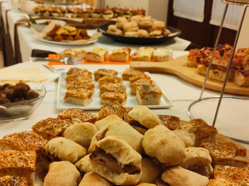 Assorted baked goods and appetizers display at Hotel Ristorante alle Querce in Castelbuono, Italy