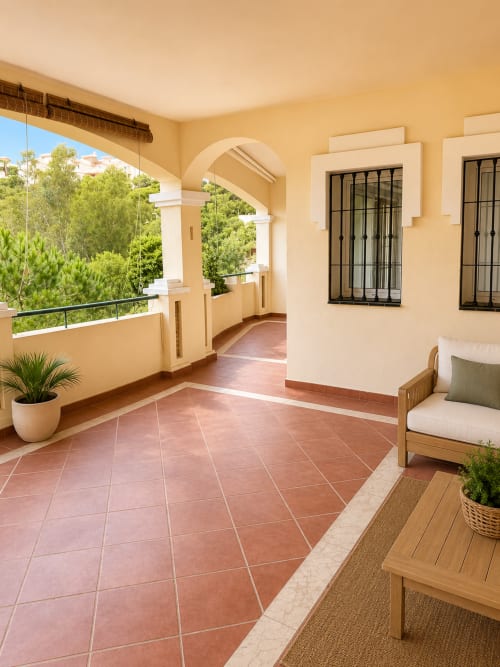 Terraza espaciosa en BH Marbella con baldosas de barro, arquitectura de arcos y vistas al jardín