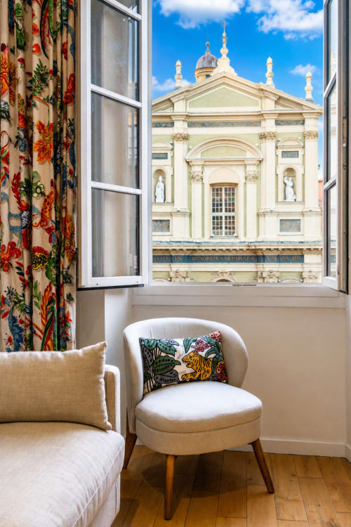 Elegant Rossetti apartment at Enjoy Nice with baroque church view, cream seating, and colorful floral decor