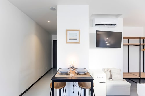 Modern Superior Studio at Benefit Collection Porto with dining table, wall-mounted TV, and contemporary furnishings