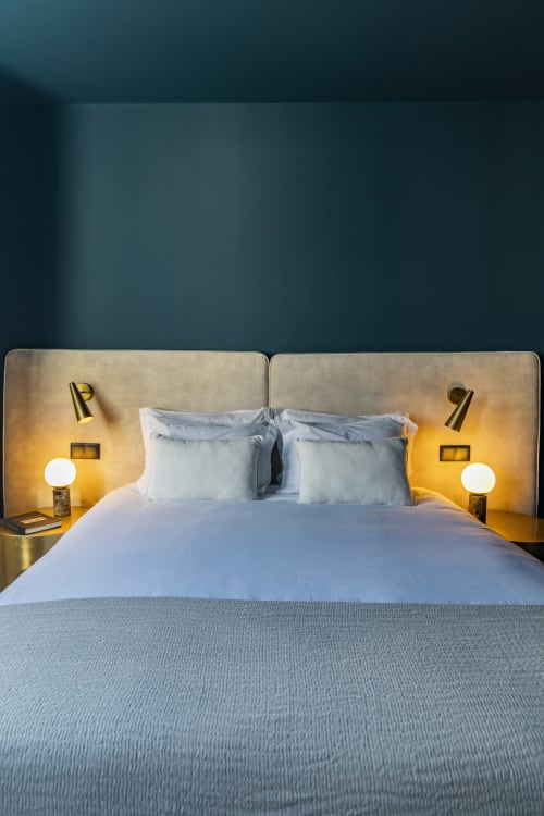Modern Deluxe Double Studio bedroom at Benefit Collection Hotel Porto with blue bedding, brass wall sconces, and beige