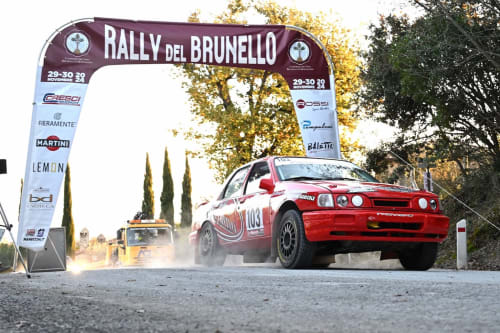 Red rally car at Rally del Brunello finish line near Buonconvento, Siena