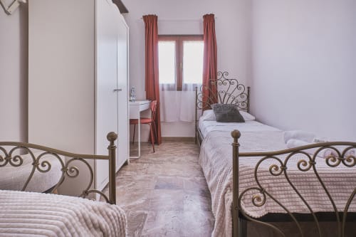Camera matrimoniale con letti in ferro battuto, scrivania e vista sulla città presso Casa Mia B&B in Italia