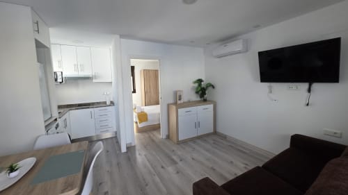 Estudio moderno en Benicàssim con salón-cocina-dormitorio abiertos, TV, sofá y diseño contemporáneo