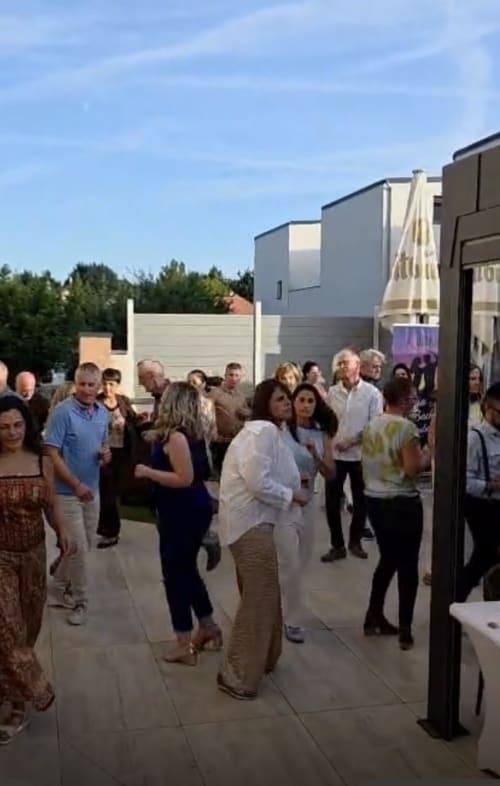 Guests gathered outdoors at Hôtel-Restaurant le S'Y in Seingbouse, France during an event or gathering on a patio area.