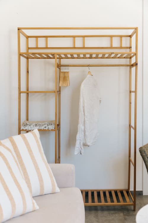 Wooden wardrobe closet with hanging white linen in rustic apartment at Tenuta Fascianello, Fasano
