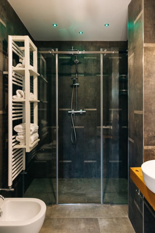 Modern bathroom with walk-in shower, heated towel rack, and dual sinks at Tenuta Fascianello, Fasano